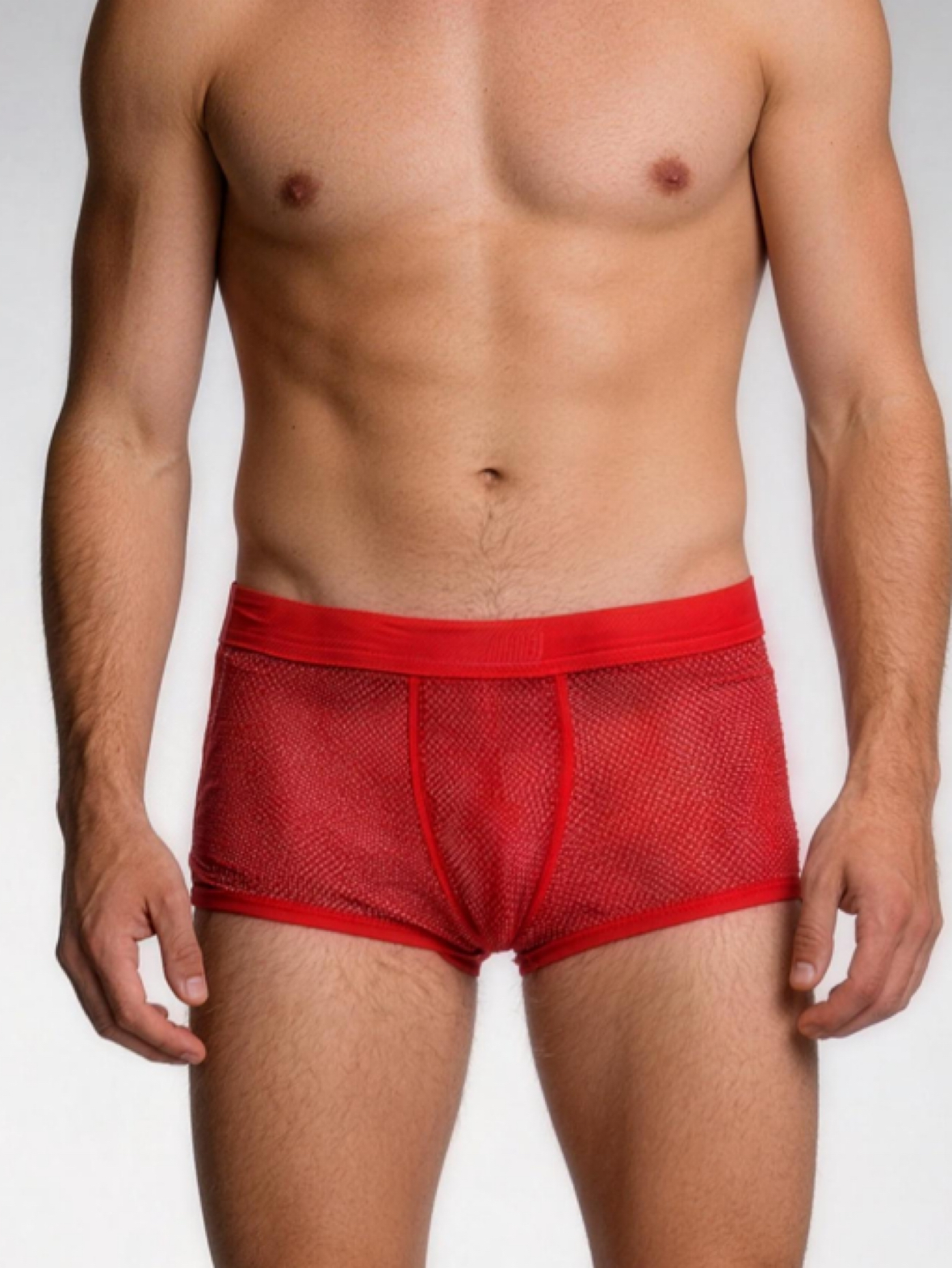 Red mesh underwear worn by a person on a plain background