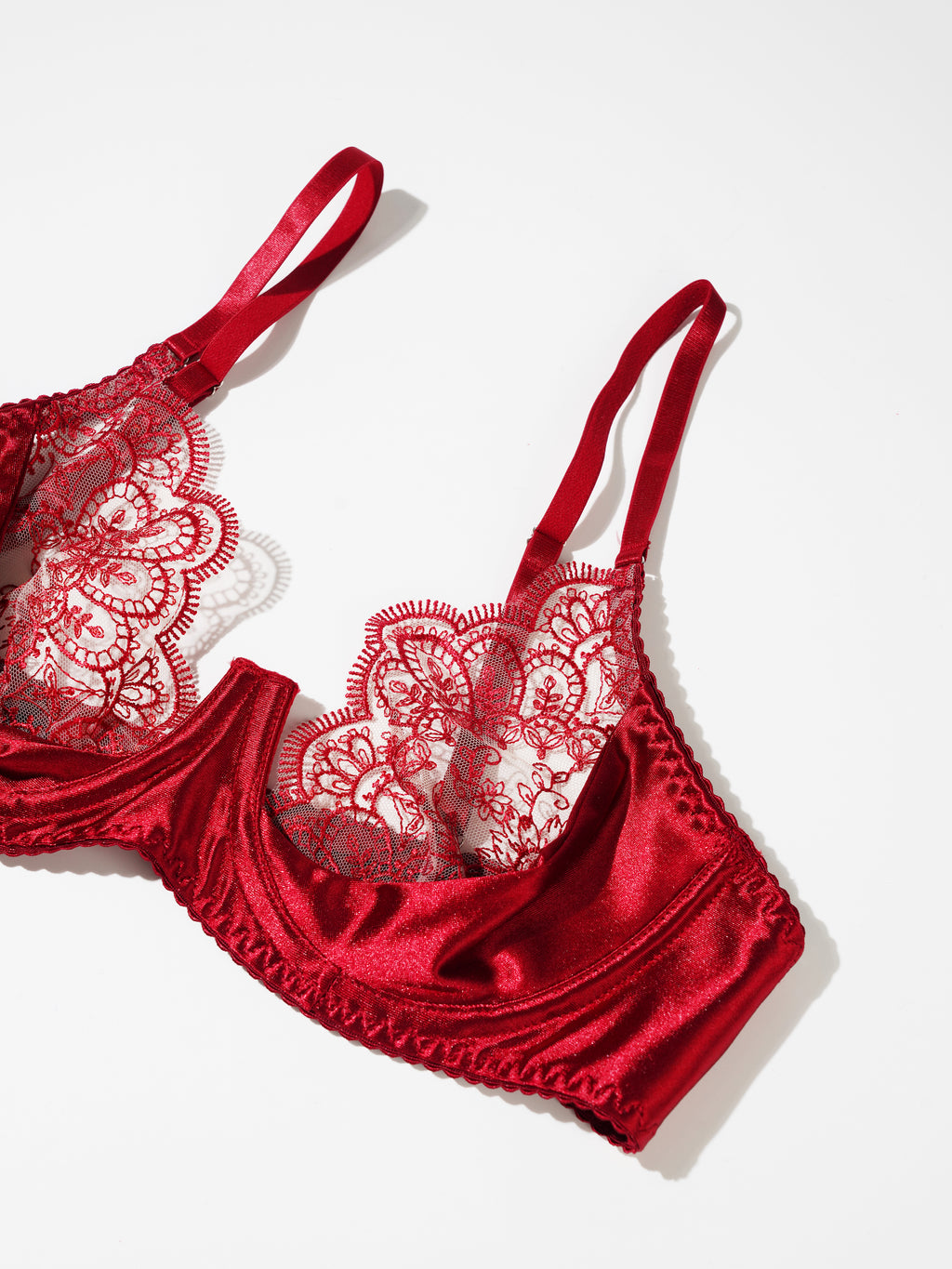 Red lace lingerie set on a white background