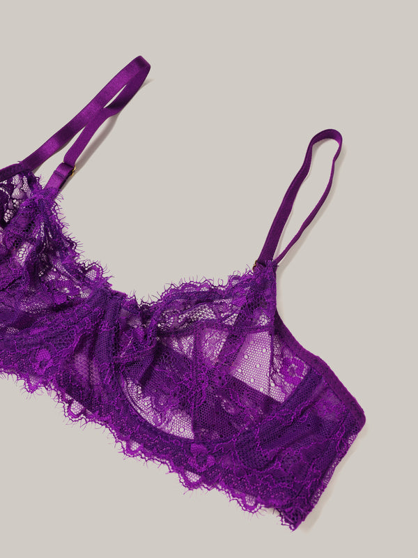 Purple lace lingerie set on a light gray background