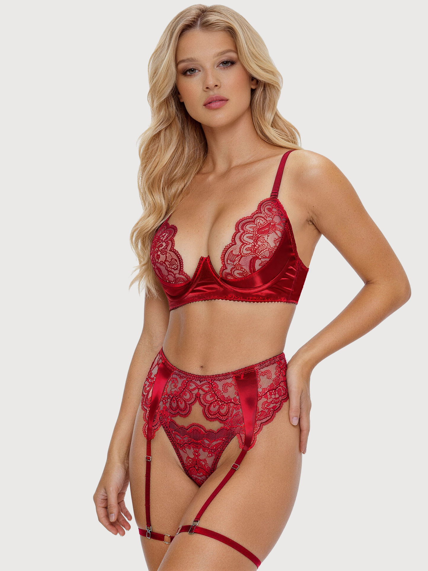 Woman wearing a red lace lingerie set on a plain background