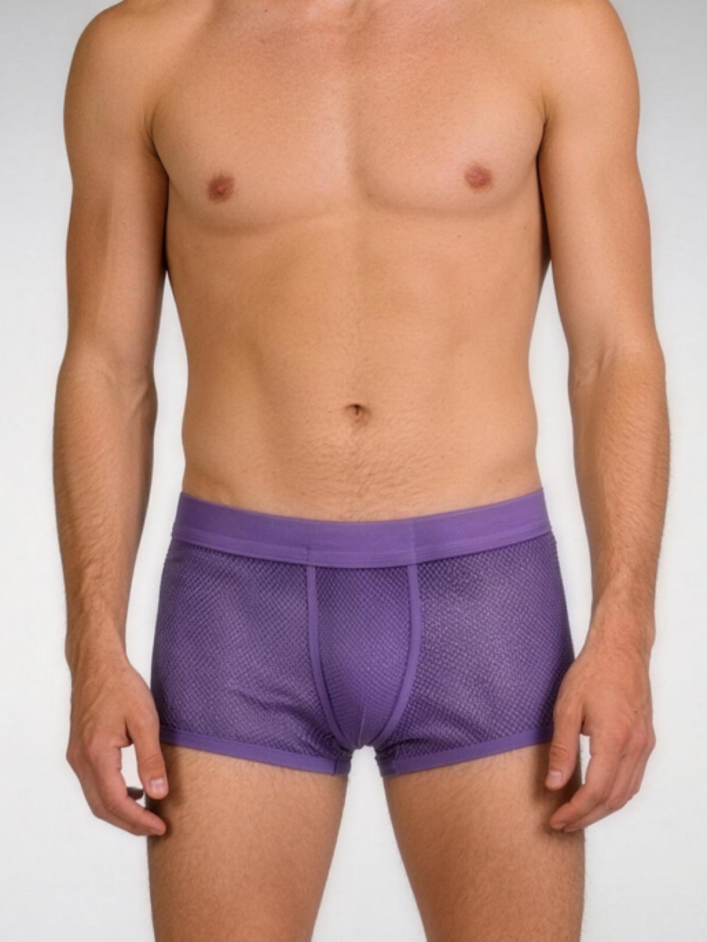 Man wearing purple mesh underwear on a white background